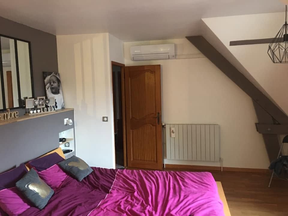 Climatiseur mural au-dessus de la porte d'une chambre rénovée